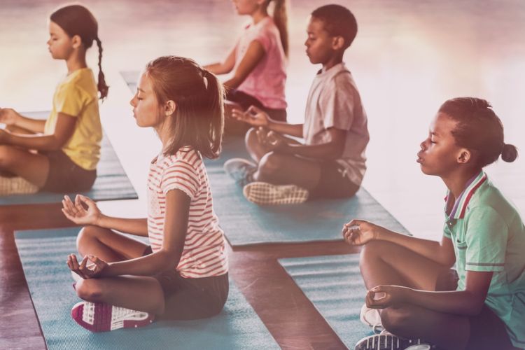 Children sitting in a meditation pose