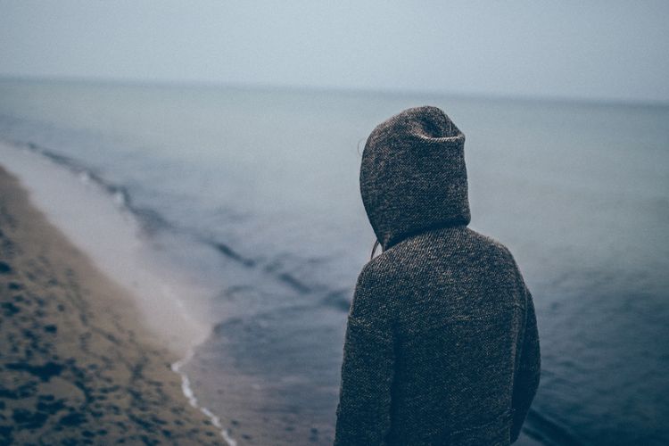 Man Looking at Sea Coast 750x500 1