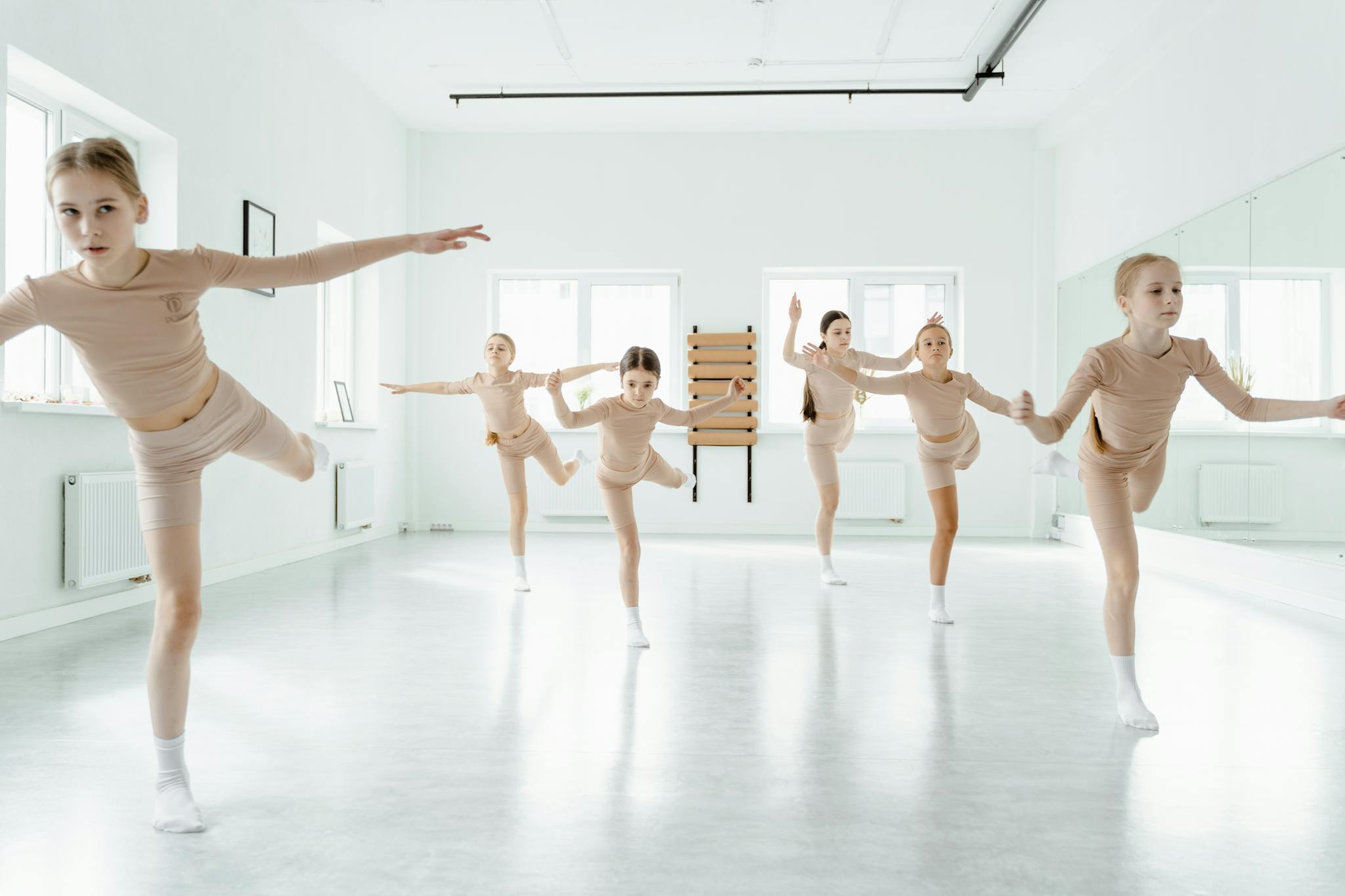 group of young girls practicing ballet in