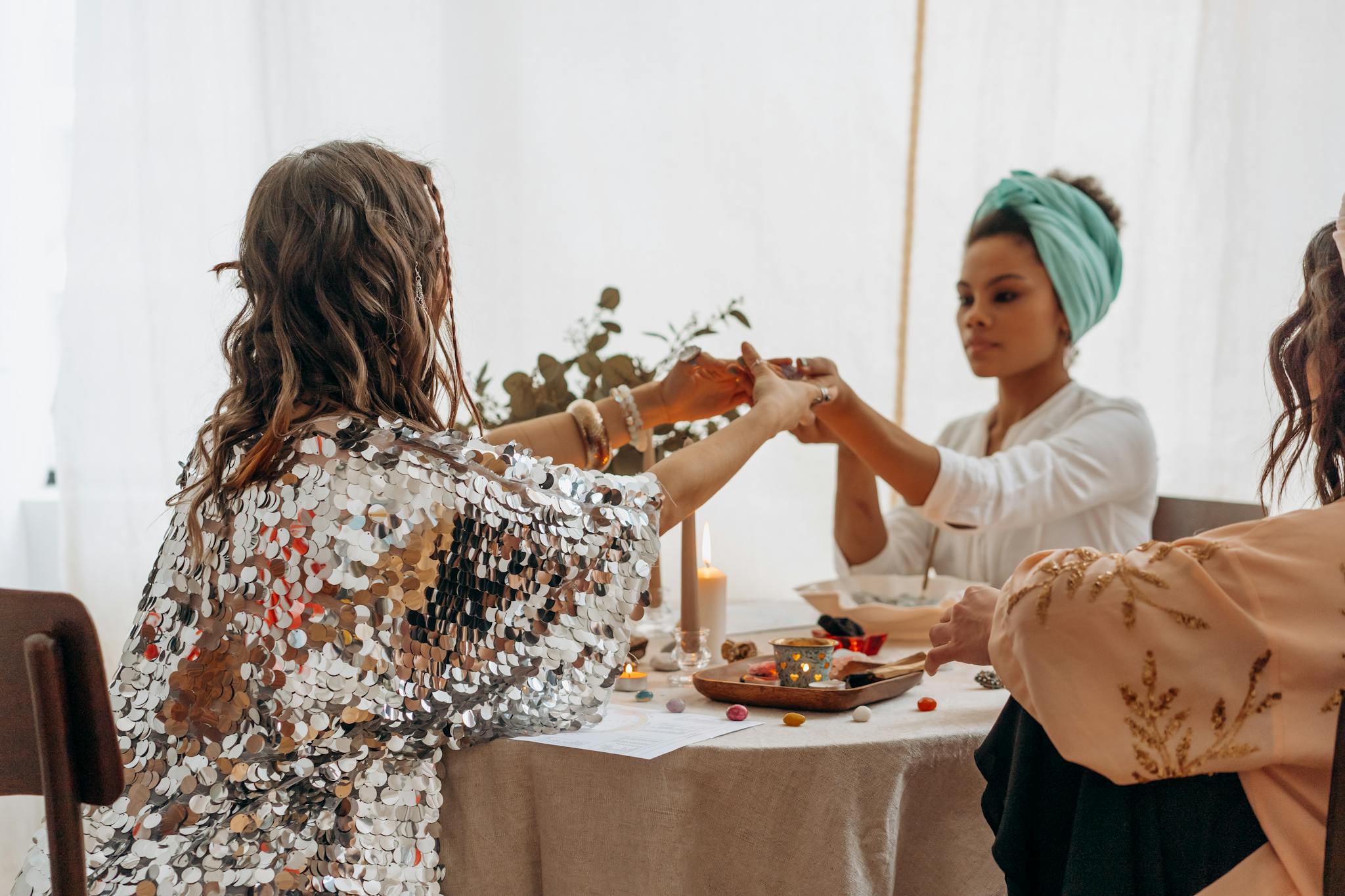 three women practicing a spiritual ritual indoors